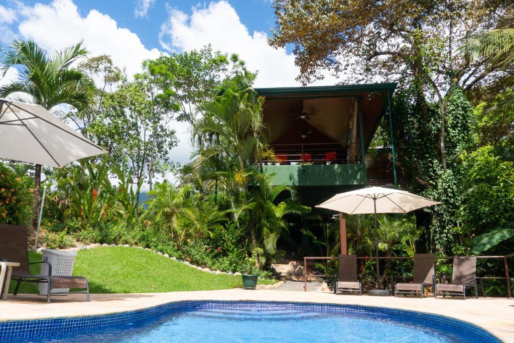a resort with a swimming pool and a house at Arbol Verde Villas in Ojochal