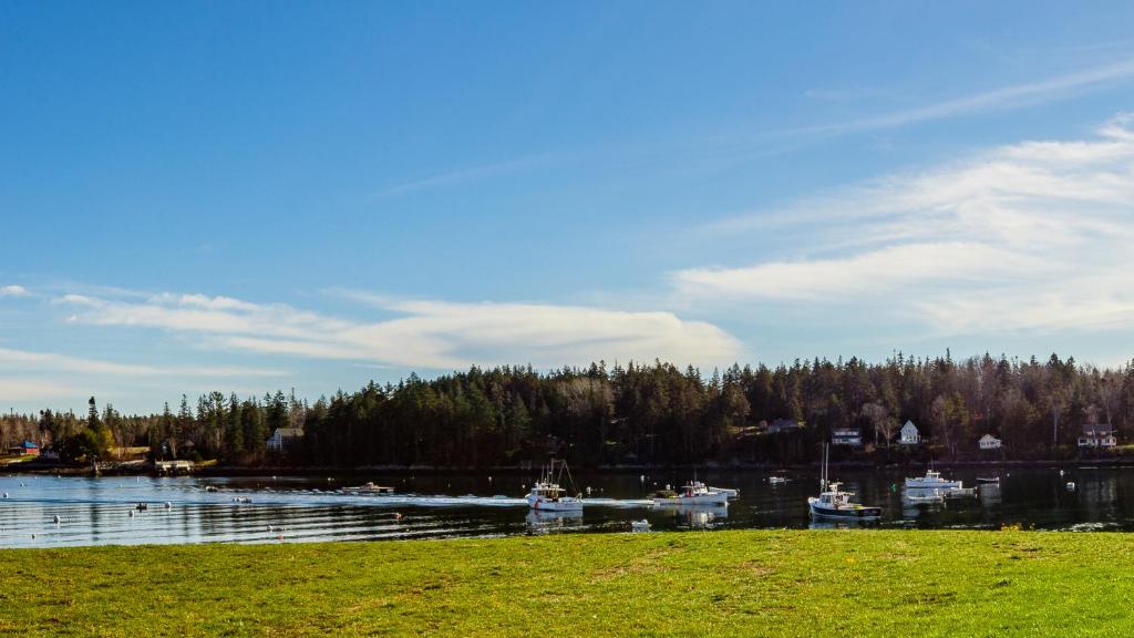 a body of water with boats in a harbor at East Wind Inn & Suites in Tenants Harbor