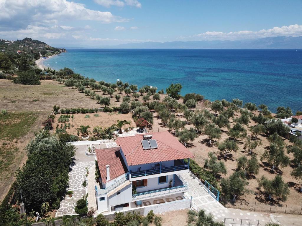 an aerial view of a house with the ocean at Akrojali in Kómboi