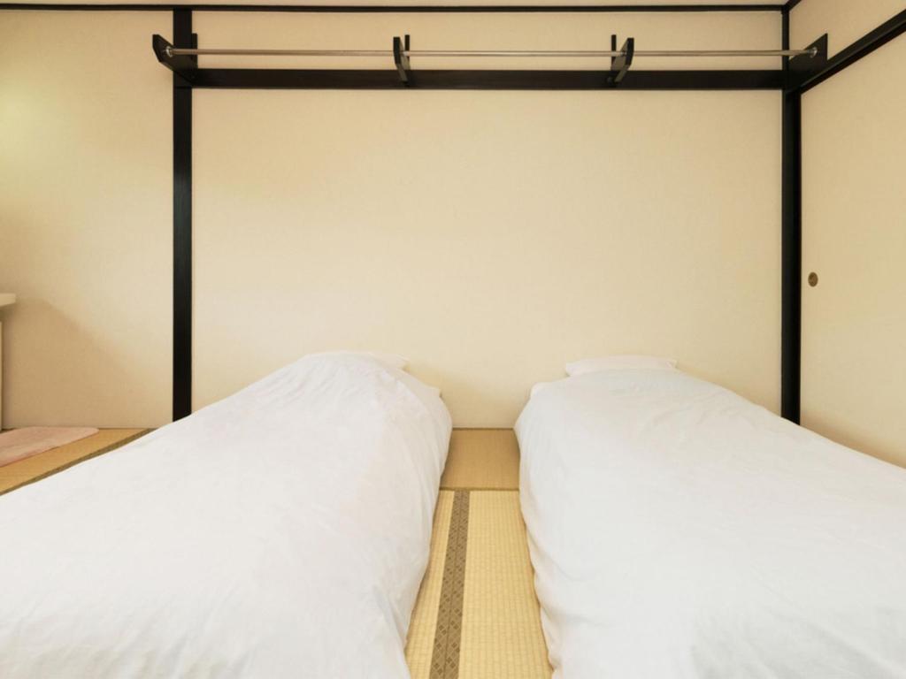 Postel nebo postele na pokoji v ubytování Sachinoyu Hotel Shiga Kogen