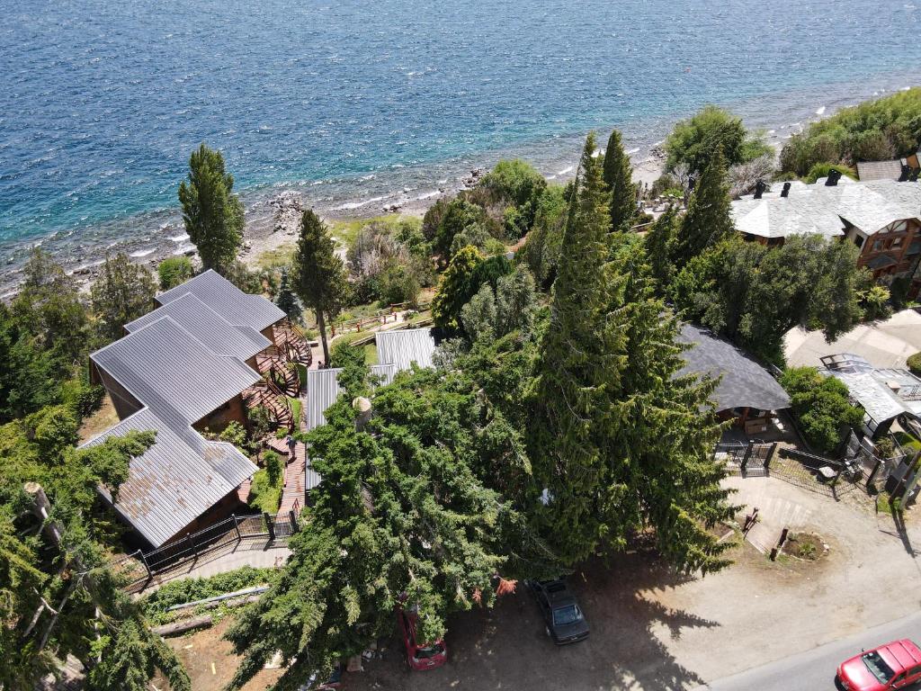 an aerial view of a house next to the ocean at Destinar Apartments in San Carlos de Bariloche