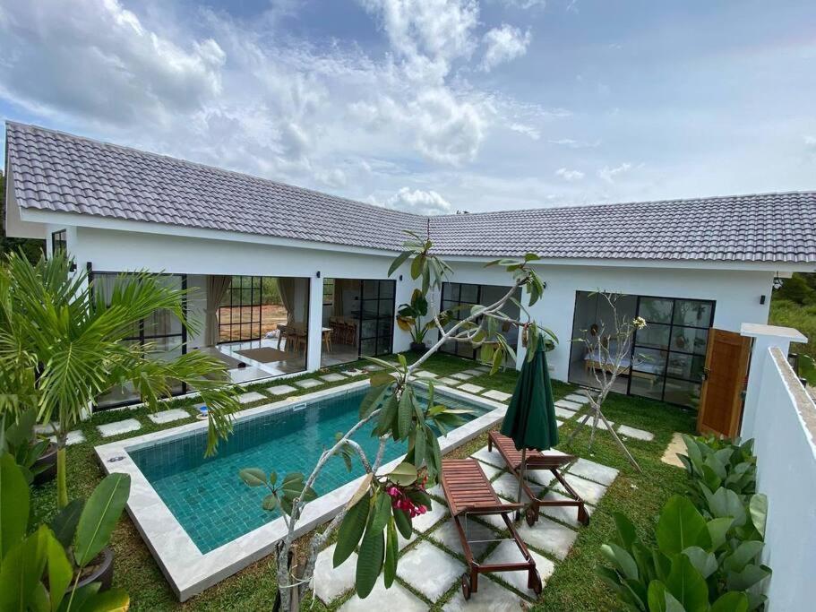 a villa with a swimming pool and a house at Allure Villa Cempaka Private Pool in Kuantan