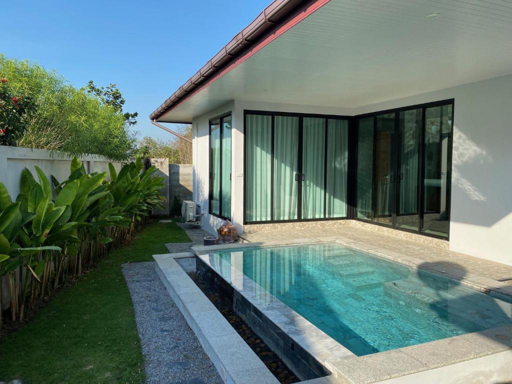 a swimming pool in the backyard of a house at Siri Thai Lodges in Hua Hin