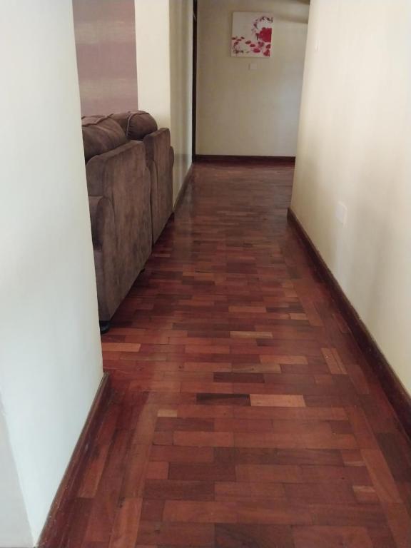 a hallway with a couch and wood floors at Sky view three bedroom in Nairobi