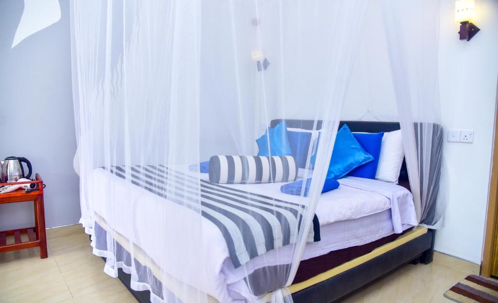 Postel nebo postele na pokoji v ubytování Ella Nimal Nest Inn