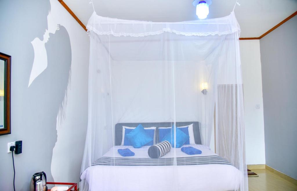 Postel nebo postele na pokoji v ubytování Ella Nimal Nest Inn