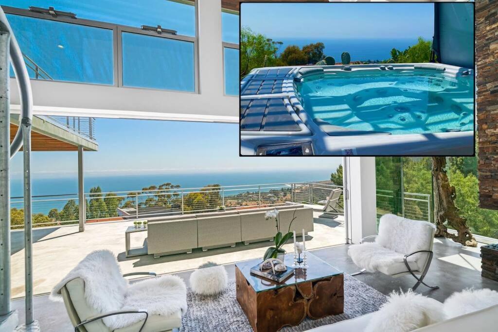 a living room with a swimming pool and a house at Malibu Glass House: Architectural w 180deg Views in Malibu