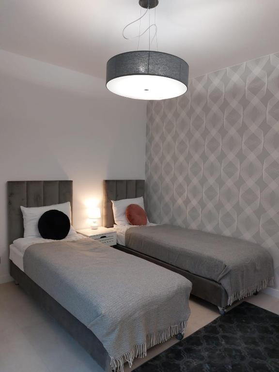 Postel nebo postele na pokoji v ubytování Klif Resort Apartamenty