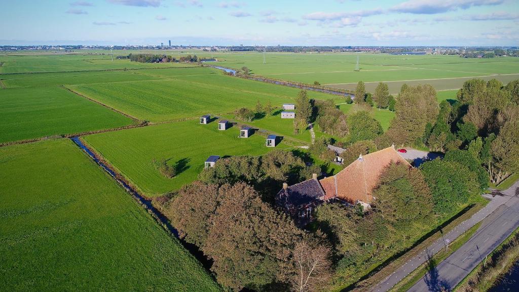 an aerial view of a farm with a house and trees at Hotel & Restaurant Weidumerhout in Weidum