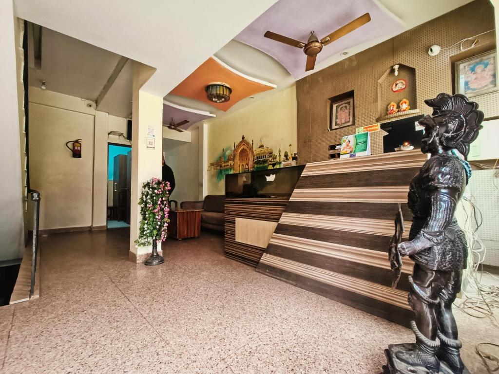 a barber shop with a statue in the lobby at Hotel Atithi Residency in Lucknow