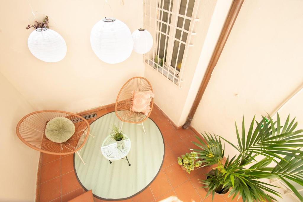 a room with a glass table and two chairs at La Corticella Luxury Suite, with Terrace in Lucca
