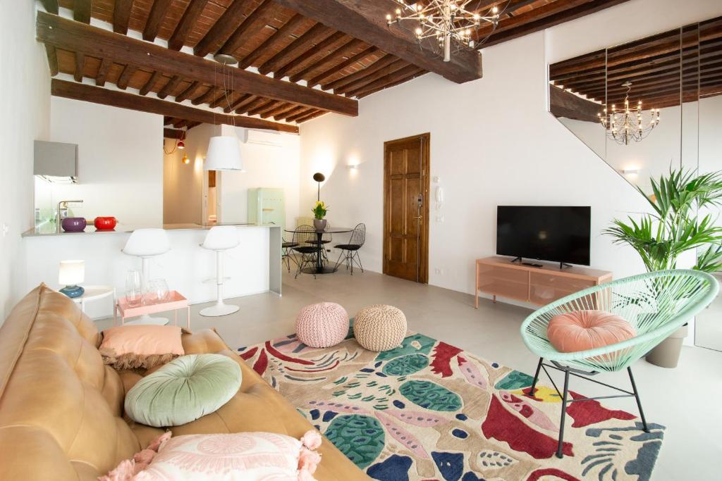 a living room with a couch and a tv at La Corticella Luxury Suite, with Terrace in Lucca