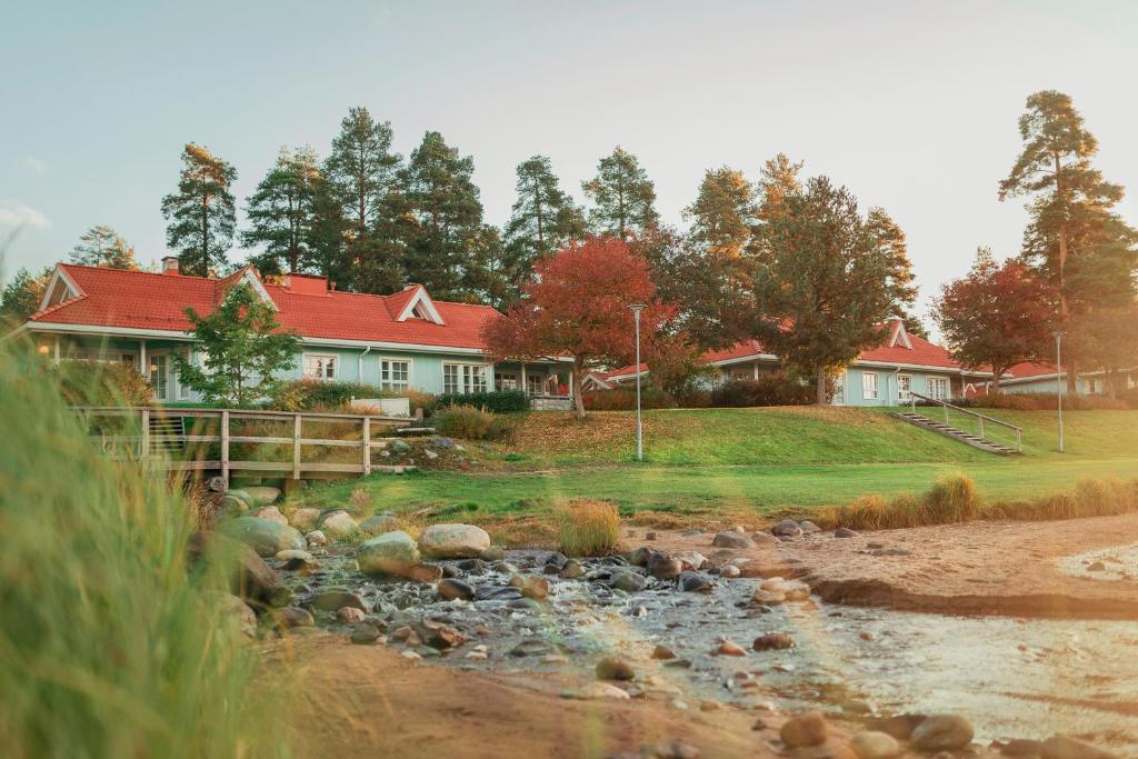 a house with a river in front of it at Holiday Club Katinkulta Apartments in Vuokatti