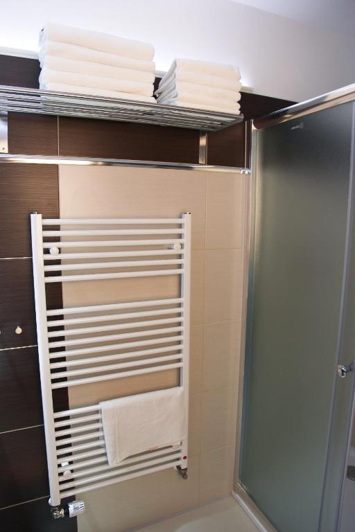 a bathroom with a towel rack with towels at Pension Dvořák in Karlovy Vary