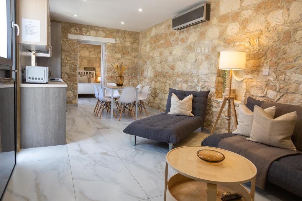 a living room with a couch and a table at Phaedrus Living: Luxury Stone House Armou in Paphos