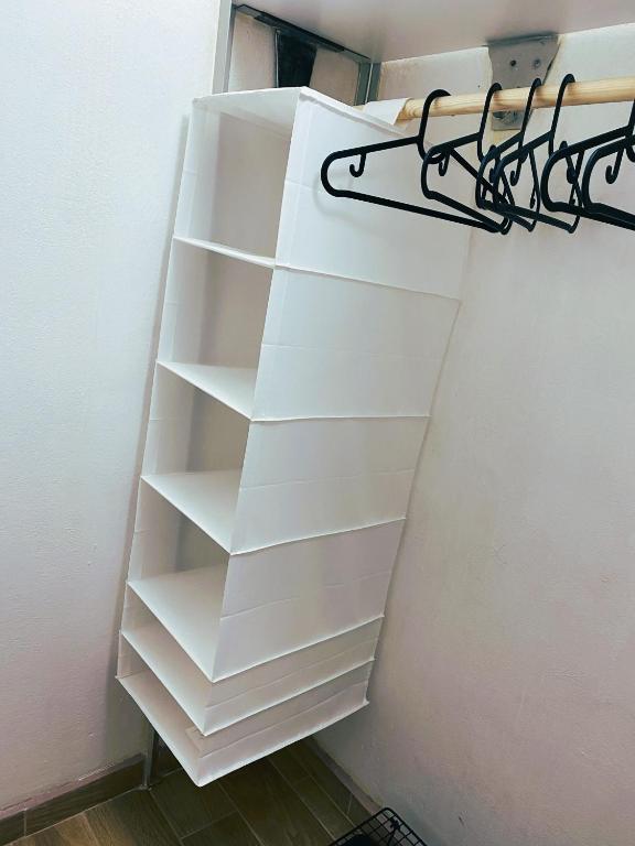 a stack of white shelves in a room at Apartman JakoDoma vlastní parkování u domu ZDARMA in Česká Lípa
