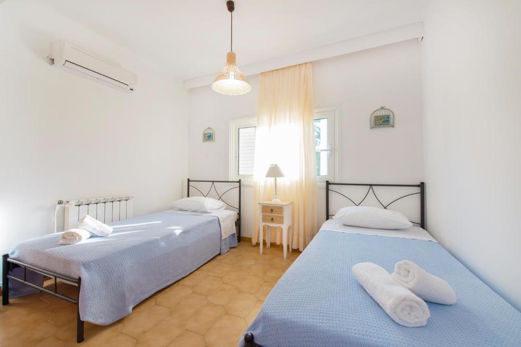 Postel nebo postele na pokoji v ubytování Villa Dora