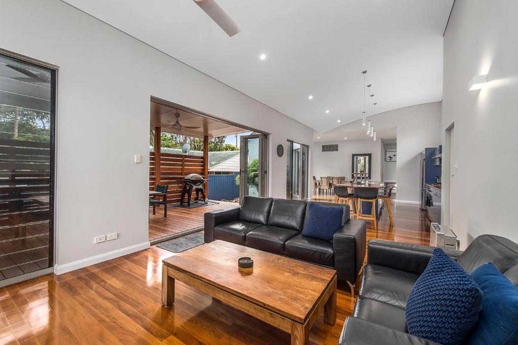 a living room with a couch and a table at Blue Beach House, 9 Cross Street, Port Macquarie in Port Macquarie
