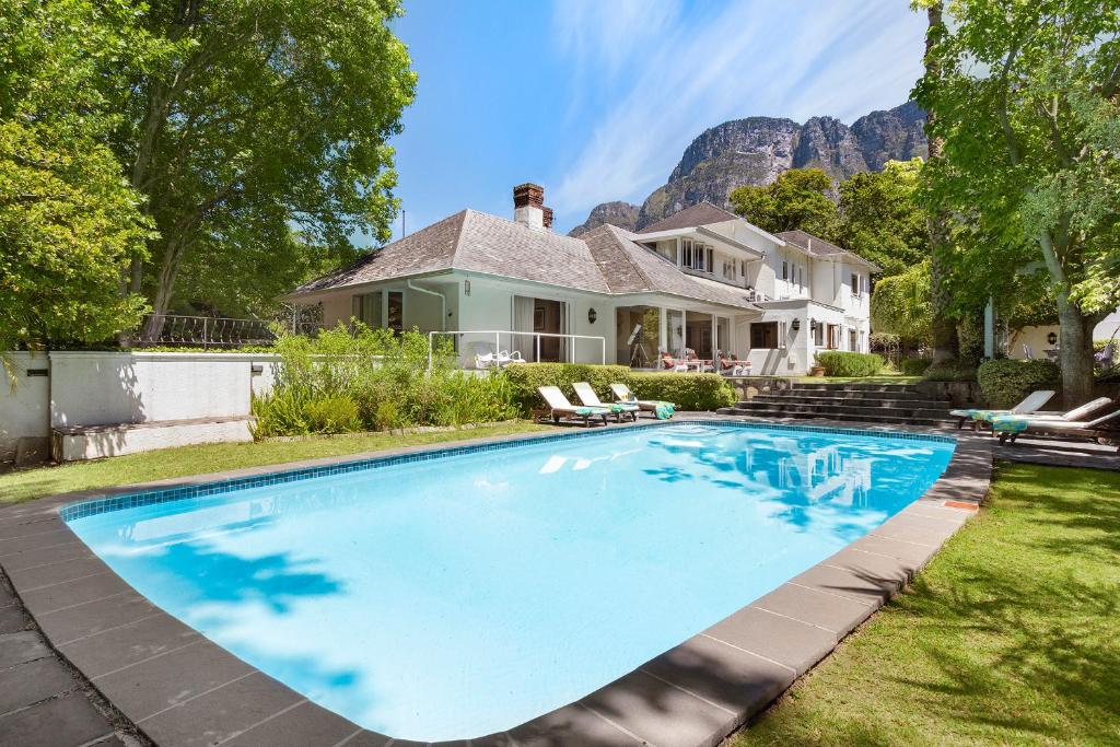 a swimming pool in the yard of a house at Craiglea Newlands - Villa with Pool & Tennis Court in Cape Town