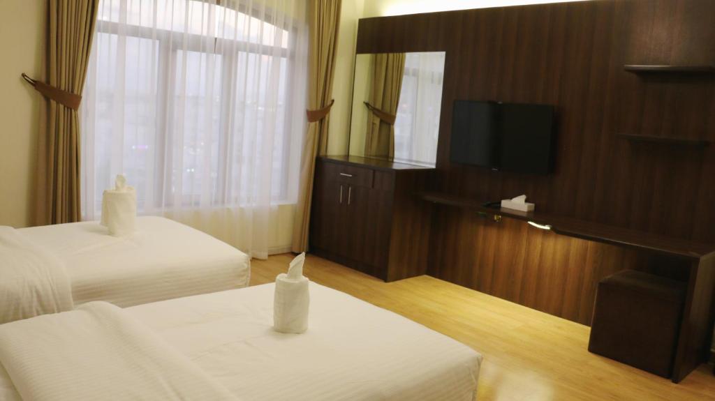 Postel nebo postele na pokoji v ubytování Weekdays Hotel
