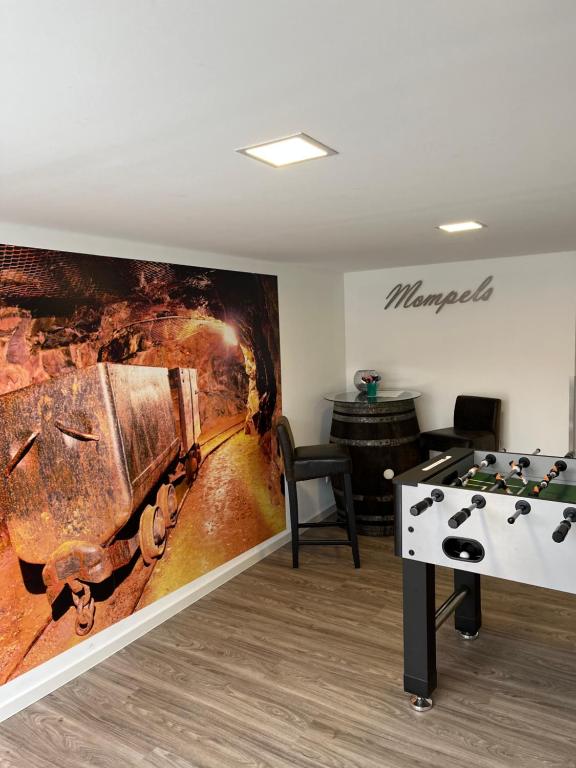 una habitación con una mesa de ping pong y una pintura en Mompels, en Rübeland