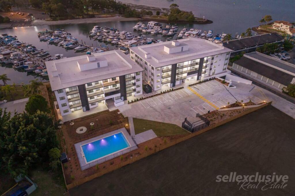 an overhead view of a building with a swimming pool at Marina Point in Sandstone Point