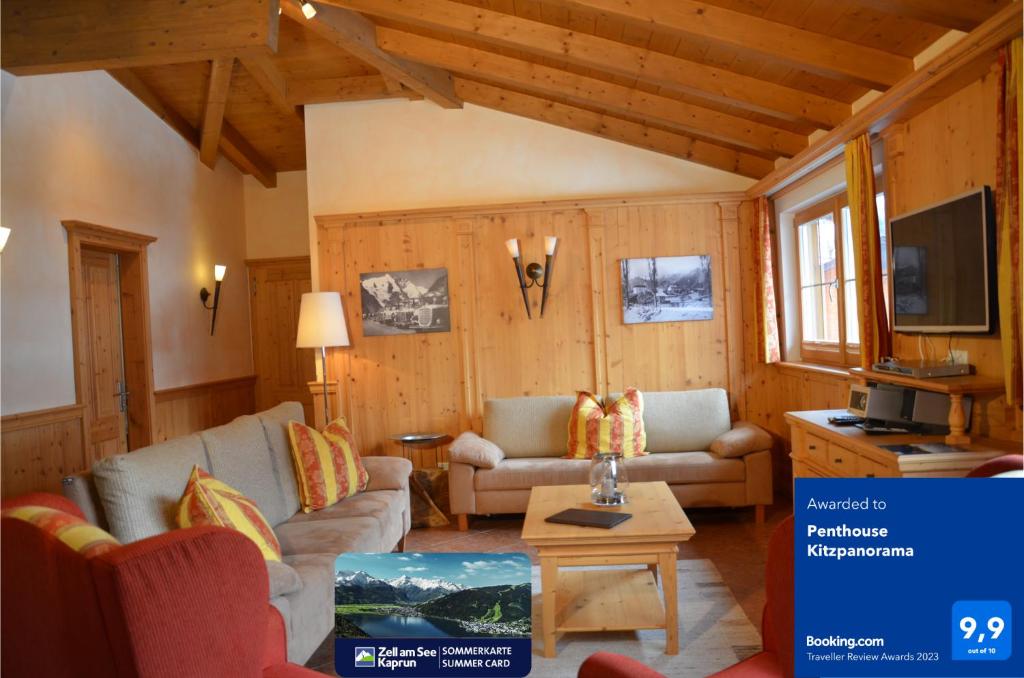 a living room with two couches and a tv at Penthouse Kitzpanorama in Kaprun