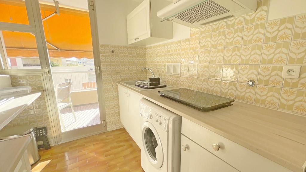 a kitchen with a washing machine on a counter at La Couronne du Cros in Cagnes-sur-Mer