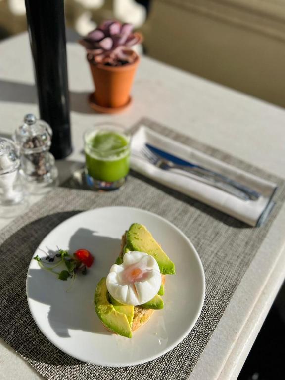 a plate of food with a egg on a table at The Principal Madrid, Small Luxury Hotels in Madrid