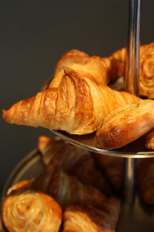 a pile of croissants on a metal tray at The Principal Madrid, Small Luxury Hotels in Madrid