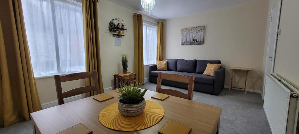 a living room with a table and a couch at Data House Holiday Apartment in Atherstone