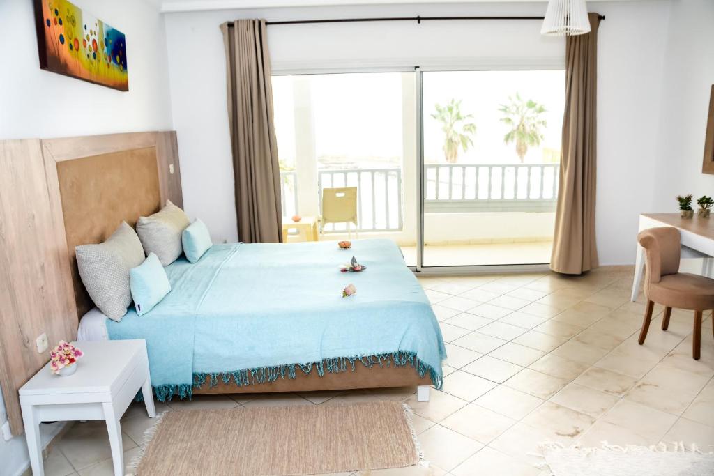 Voodi või voodid majutusasutuse Hotel El Habib Monastir toas