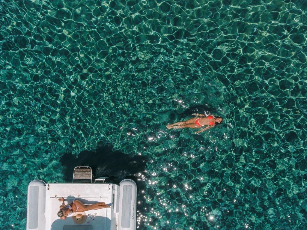 a person swimming in a pool of water at Hotel Perrakis in Kipri