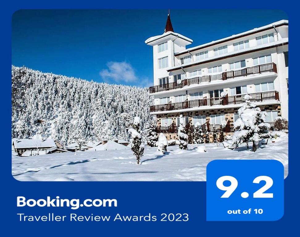 a hotel with snow covered trees in front of a building at Eagle Rock View Apartment, Borovets in Beli Iskar