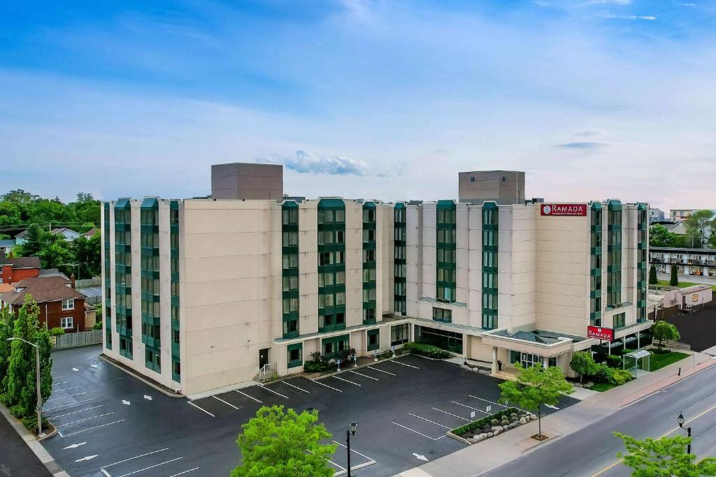 an aerial view of a large white building with a parking lot at Ramada By Wyndham Niagara Falls near the Falls in Niagara Falls