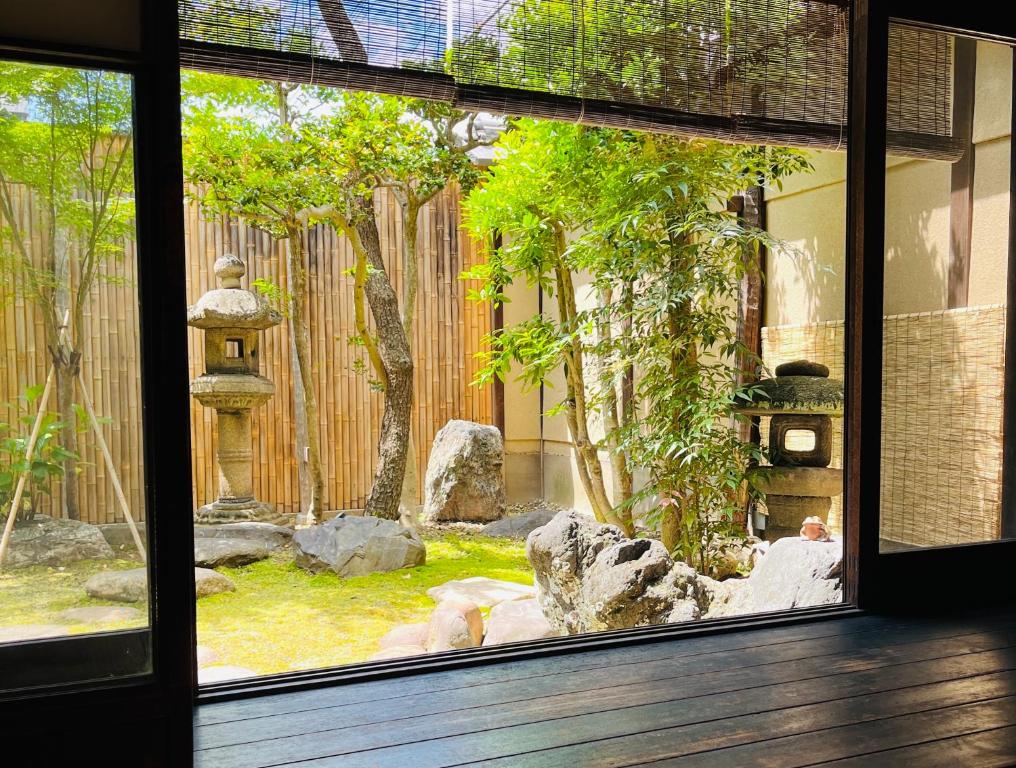 a view of a garden from a window at Tansada Heritage Machiya in Kyoto