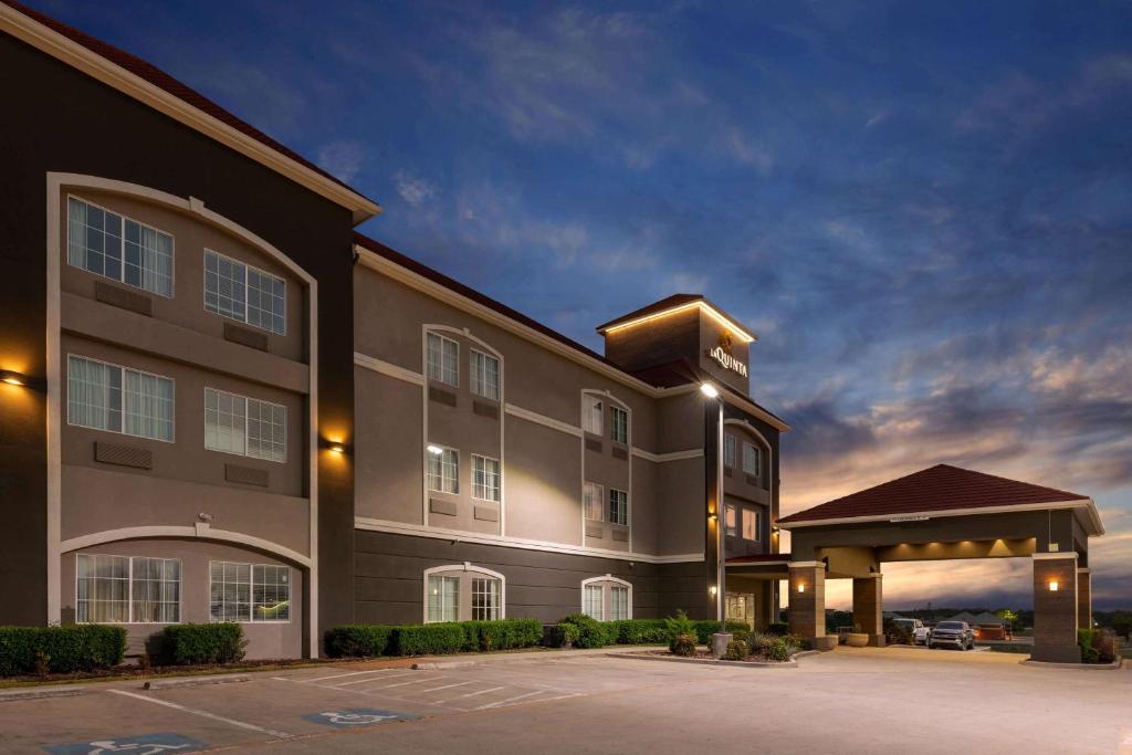 a large building with a parking lot in front of it at La Quinta by Wyndham Bridgeport in Bridgeport