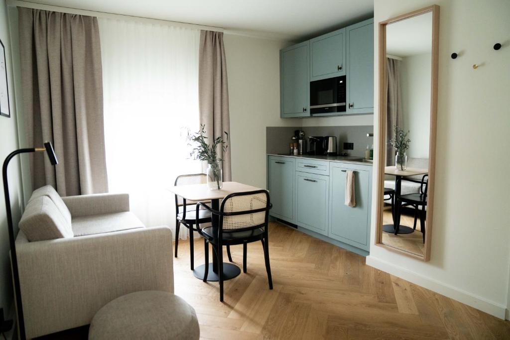 a living room with a table and a kitchen at Bob W Lübeck Old Town in Lübeck