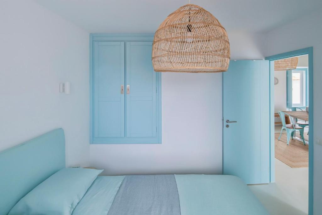 a bedroom with a bed and a wicker basket at Casa Azul do Olival in Alcácer do Sal
