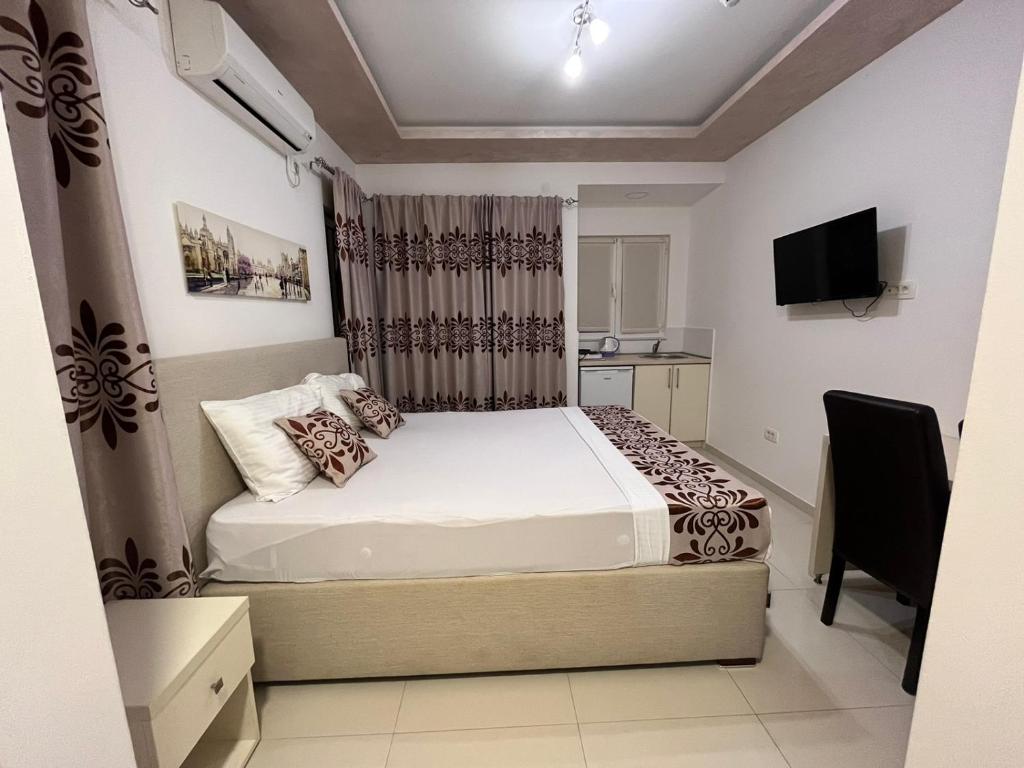 a bedroom with a bed and a television in it at Pearl Apartments in Budva