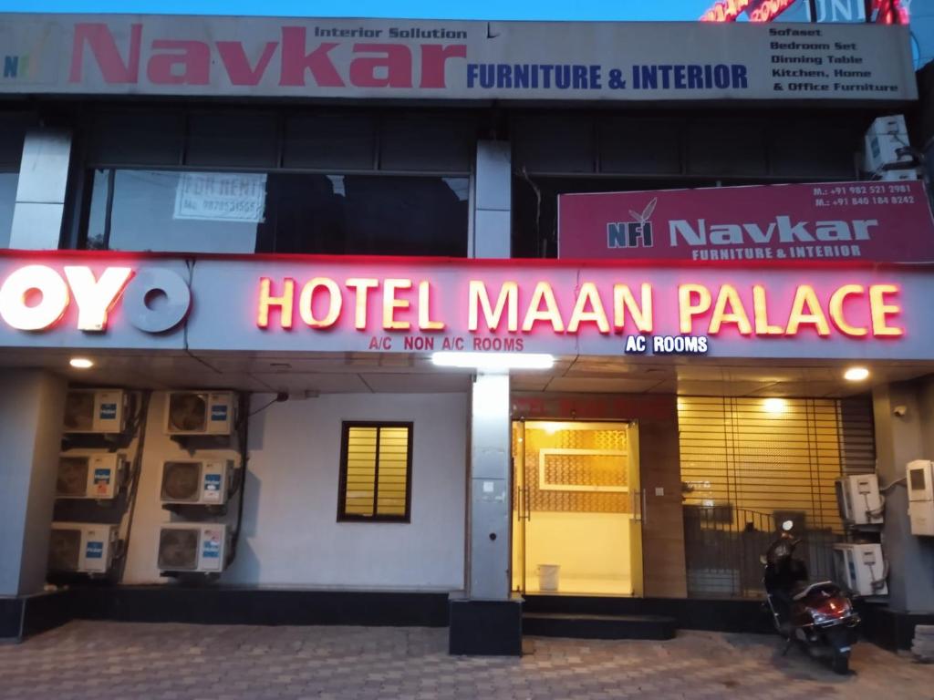 a hotel manandan palace with a sign in front of it at Hotel Maan Palace in Ahmedabad