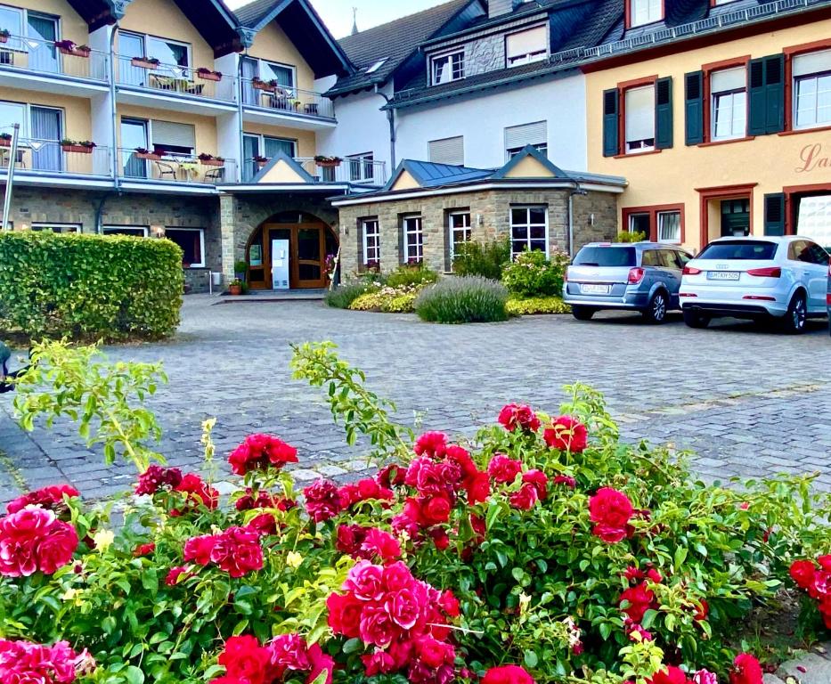 a bunch of red flowers in front of a building at Landhaus Schend in Immerath