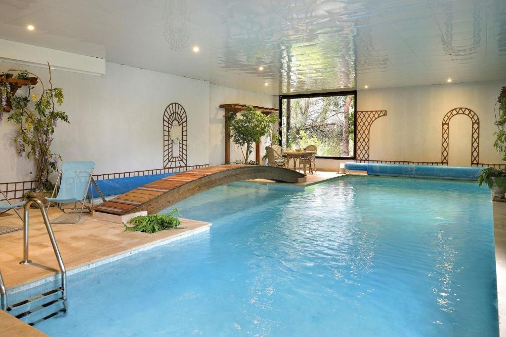 a swimming pool with a large blue pool at La Rozeliere 