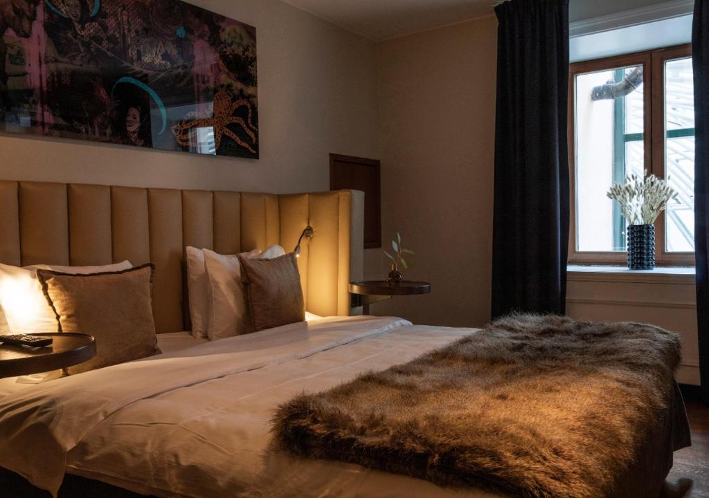 a bedroom with a bed with a fur blanket on it at Berns, Historical Boutique Hotel & House of Entertainment since 1863 in Stockholm