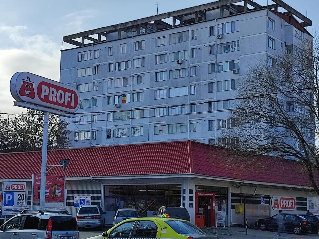 a parking lot with cars parked in front of a hotel at APARTAMENT HD ELI in Hunedoara