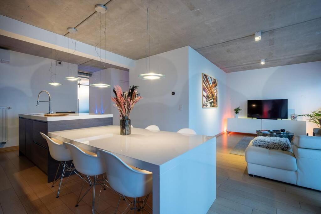 a kitchen with a island in the middle of a room at London 993 Loft 402 in Antwerp