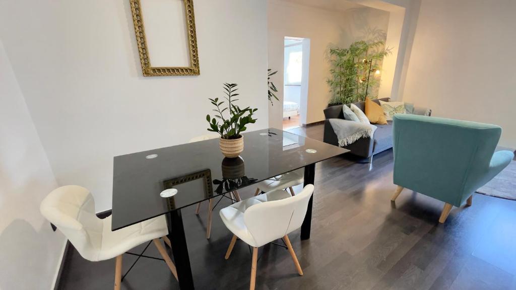 einen Esstisch und Stühle im Wohnzimmer in der Unterkunft Apartamento T2 com Terraço grande in Quarteira