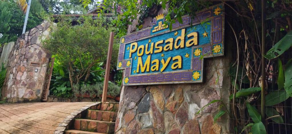 a sign for a poshka maya restaurant on a wall at Pousada Maya in Alto Paraíso de Goiás