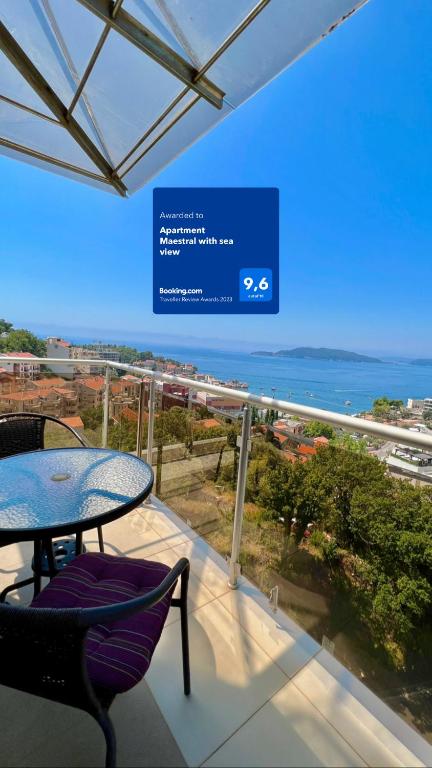 a balcony with a table and chairs and the ocean at Apartment Maestral with sea view in Pržno