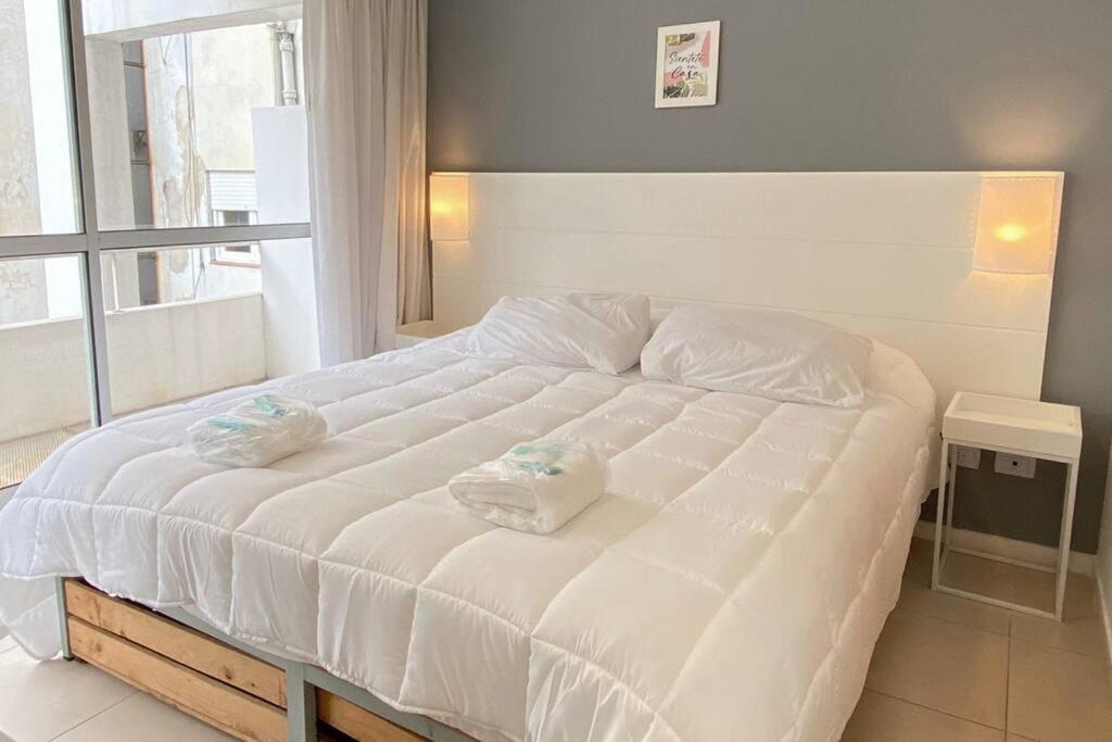Una cama blanca con dos toallas encima. en BALC0408 Excelente departamento Studio por San Telmo en Buenos Aires